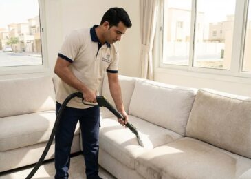 عامل محترف من شركة المدينة أفضل شركة تنظيف كنب في الحومة يقوم بغسيل كنب فاتح اللون باستخدام ماكينة البخار.