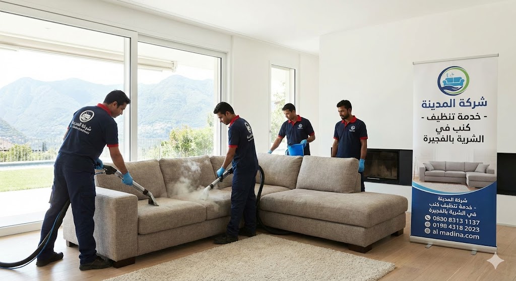 فريق عمل شركة المدينة، بصفتها شركة تنظيف كنب في الشرية، يستخدم أجهزة البخار لتنظيف كنب زاوية كبير في فيلا ذات إطلالة جبلية، مع وجود لافتة إعلانية توضح الخدمة والموقع.